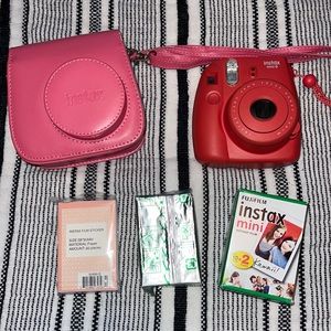 Pink Polaroid camera with extra film and case